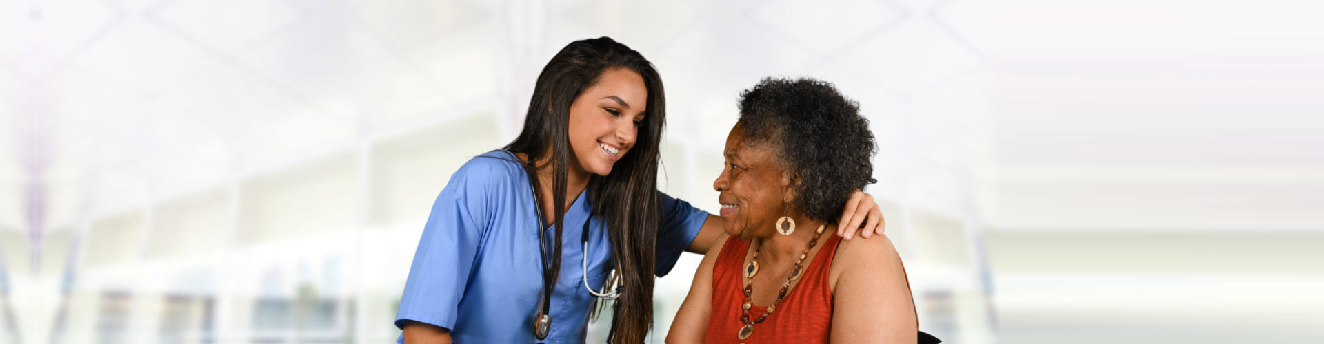 elder woman with caregiver looking at each other